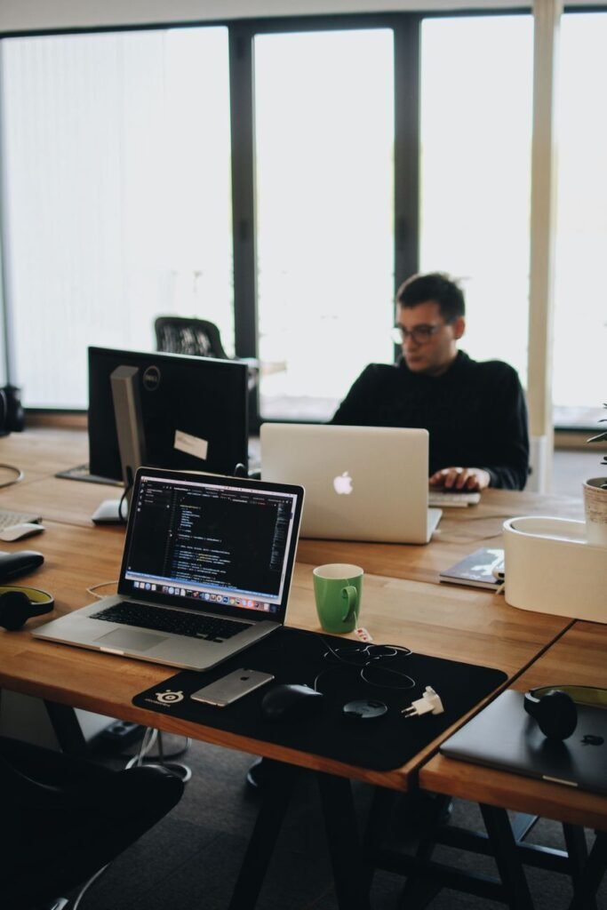 Developer reviewing website maintenance cost and updates on a laptop